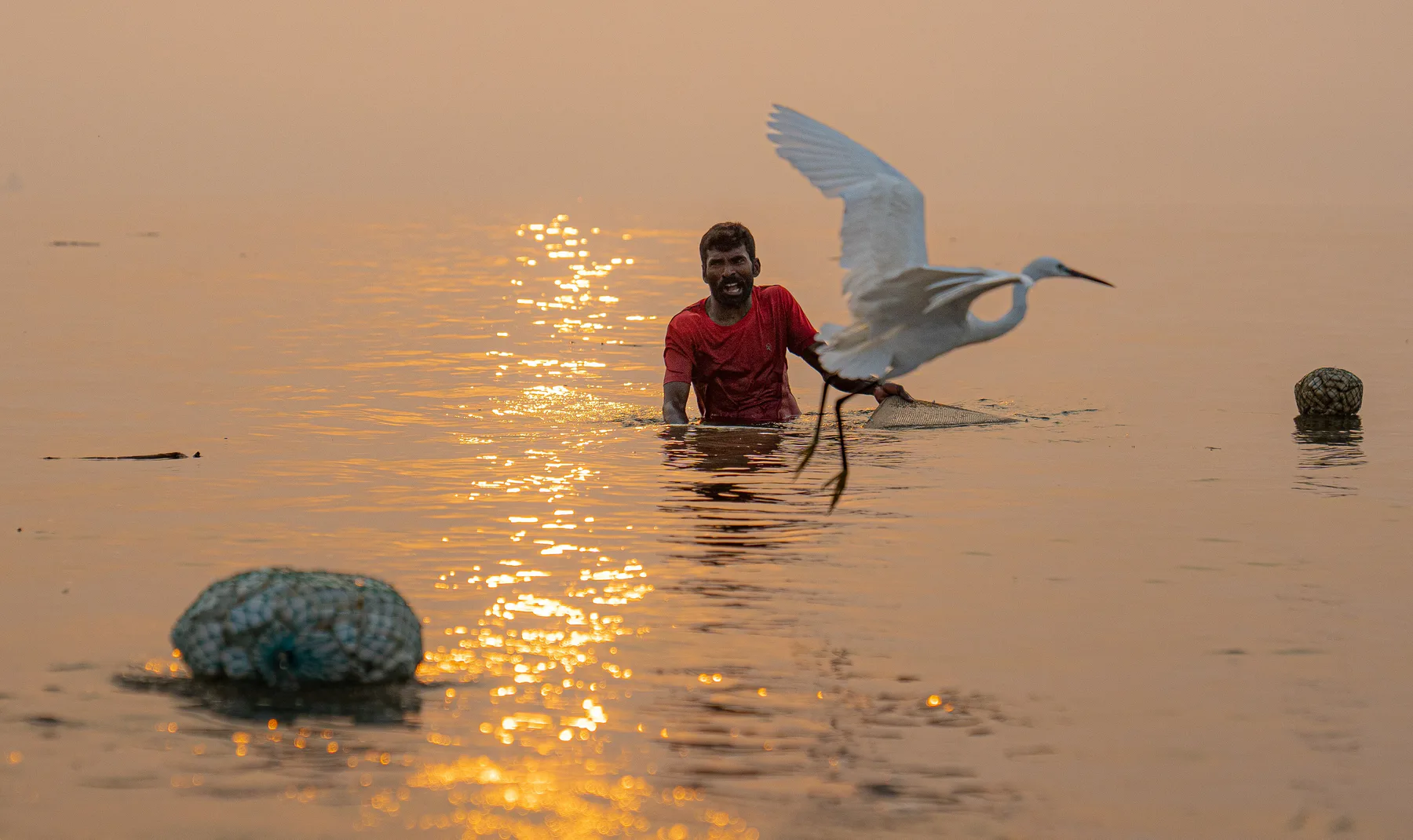Fishermen in waves at Kakinada Beach